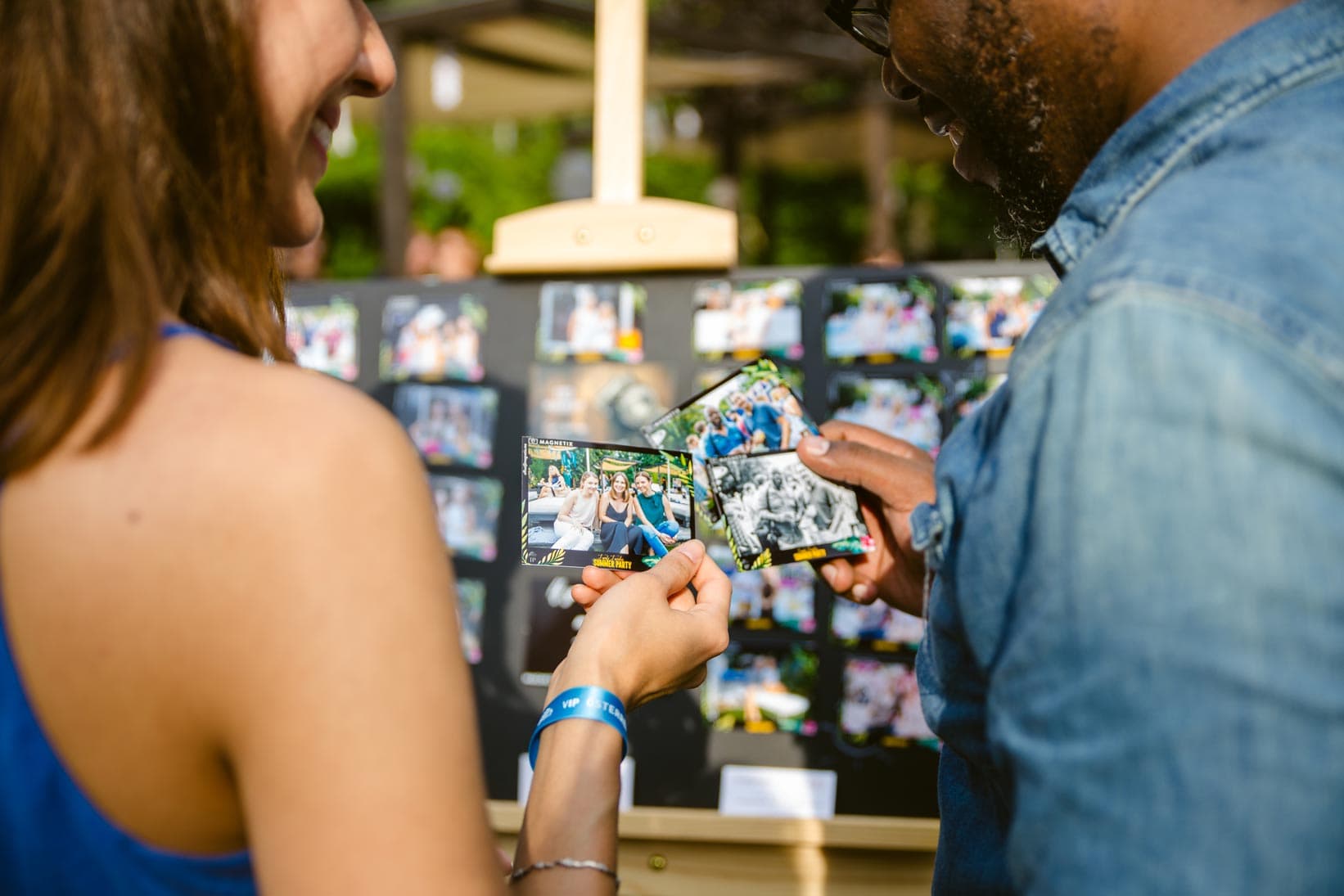 Guests holding their finished photo magnets at the event.